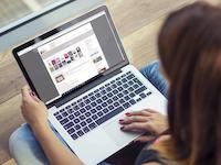 Frau mit Laptop stöbert im Online-Katalog der Stadtbibliothek Erlangen.
